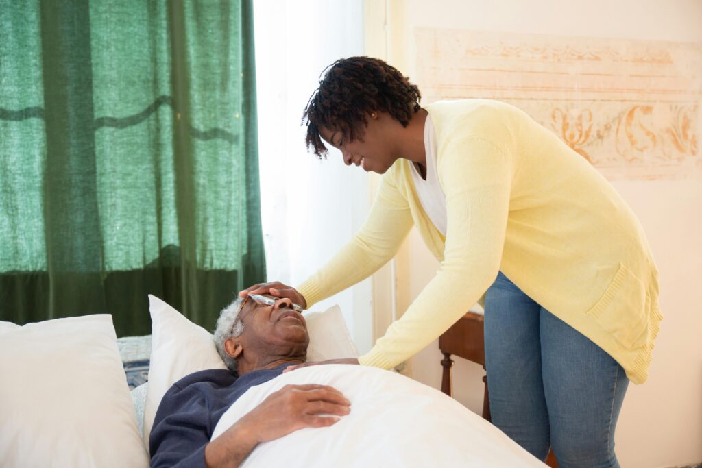 A loving daughter tends to her elderly father at home, offering comfort and care.